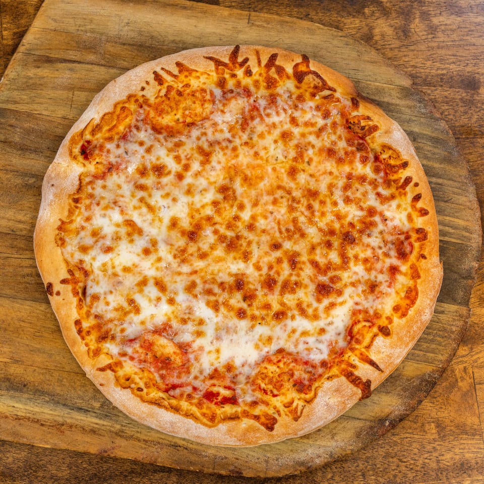 A whole cheese pizza with melted mozzarella and a golden crust, on a wooden pizza peel.